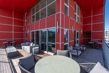 A red building with a patio area.